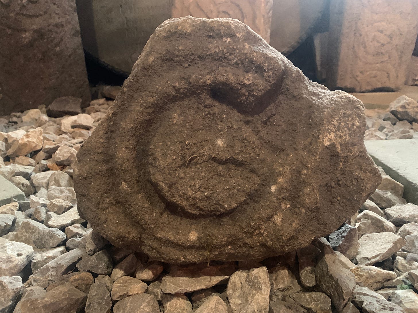 A spiral runic inscription on a rock, placed upon pebbles