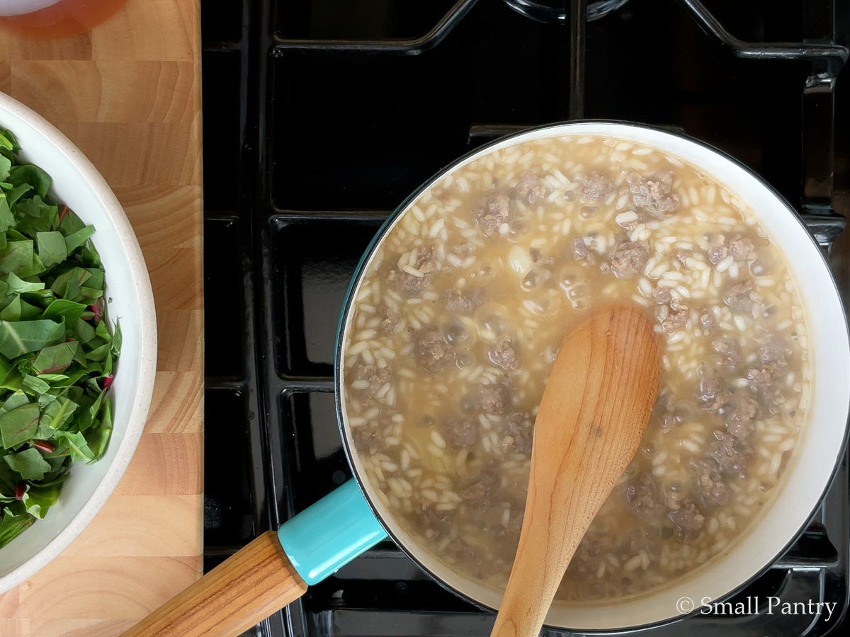Sausage risotto simmering on the stove