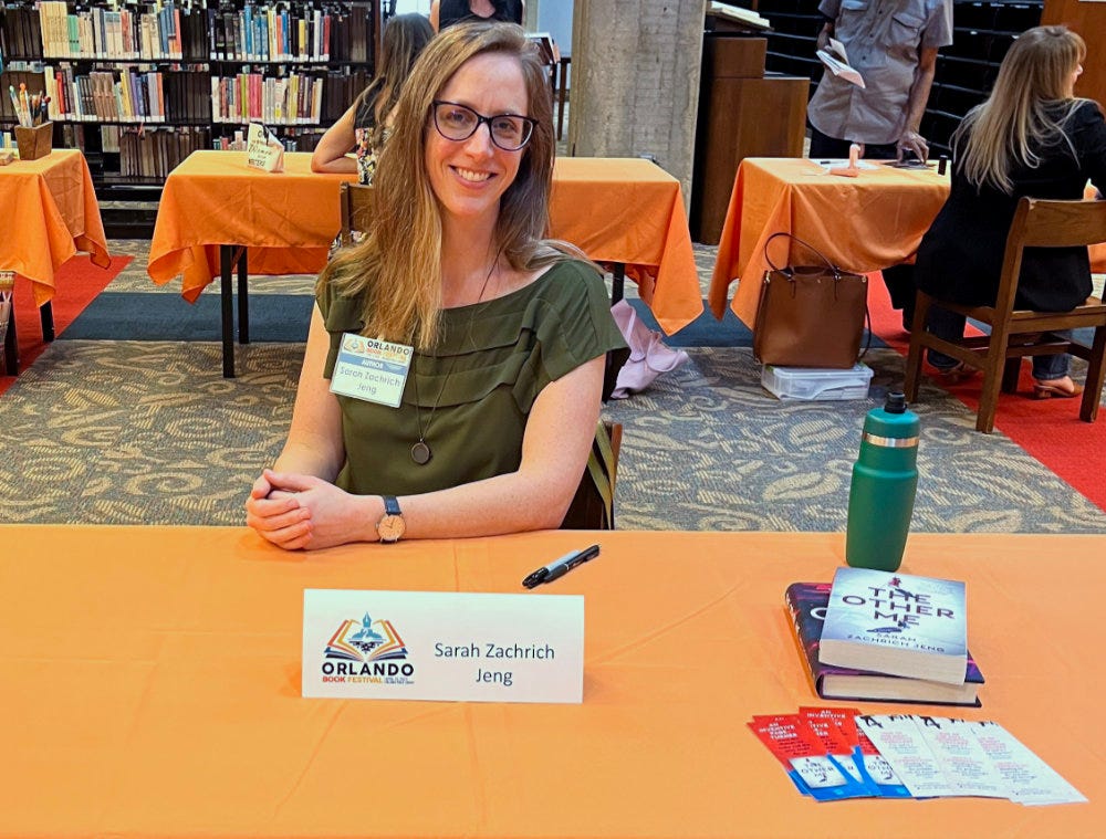 Author Sarah Zachrich Jeng at a book signing table at the Orlando Book Festival, April 2023