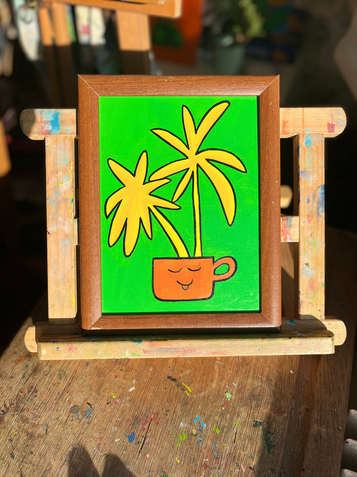 Two yellow plants in an orange mug on a green background