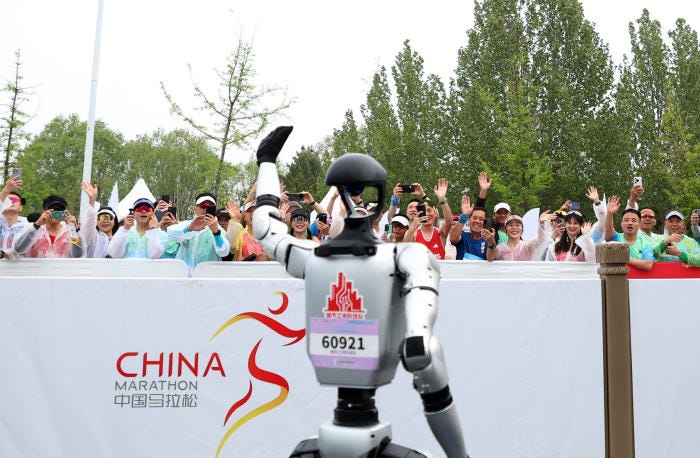 A robot participant waves at the Beijing half-marathon.