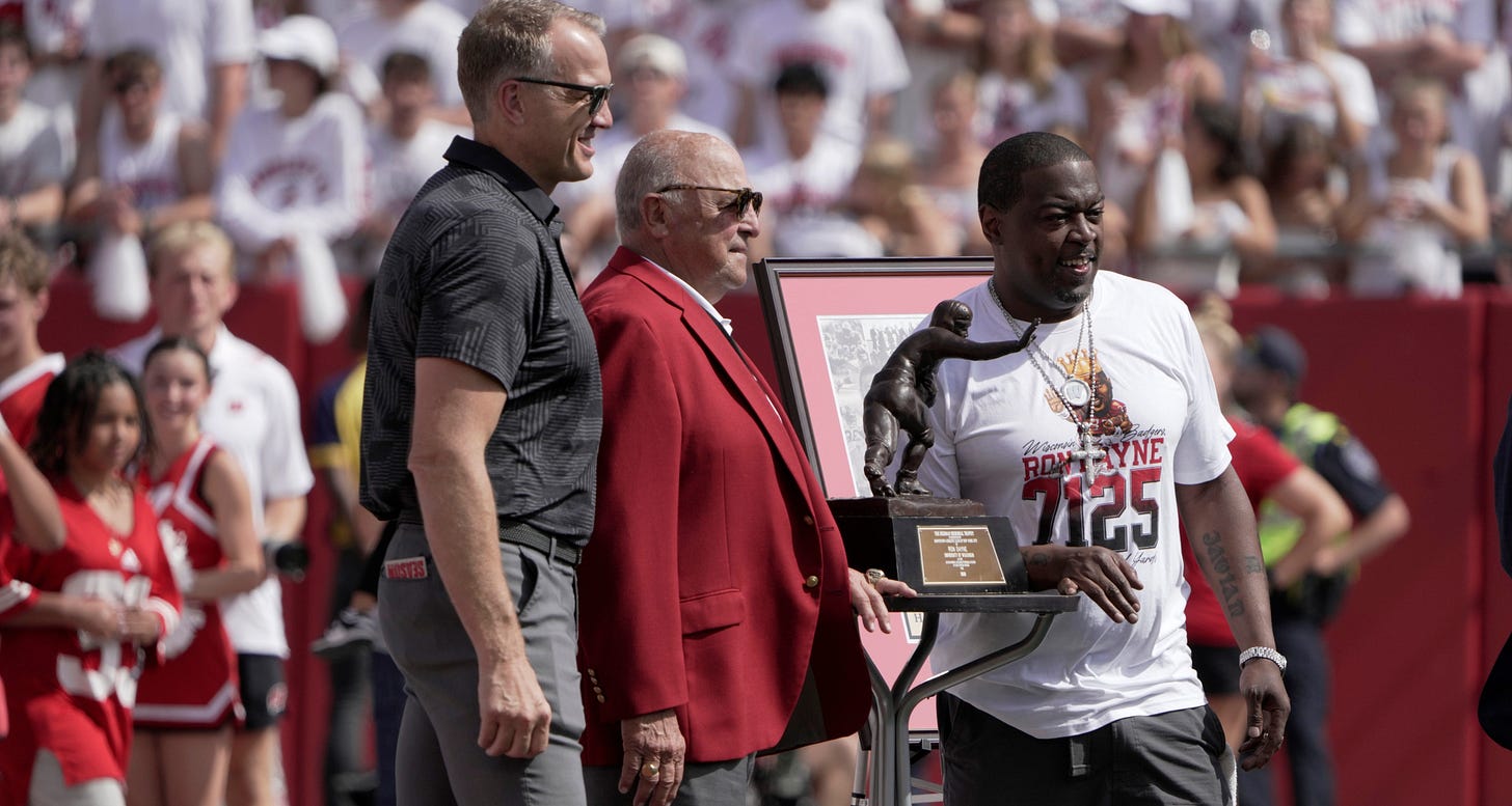 Wisconsin Badgers athletic director Chris McIntosh and former head coach and athletic director Barry Alvarez pictured with Ron Dayne