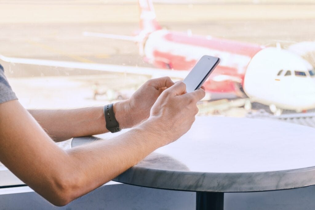 Man texting at airport