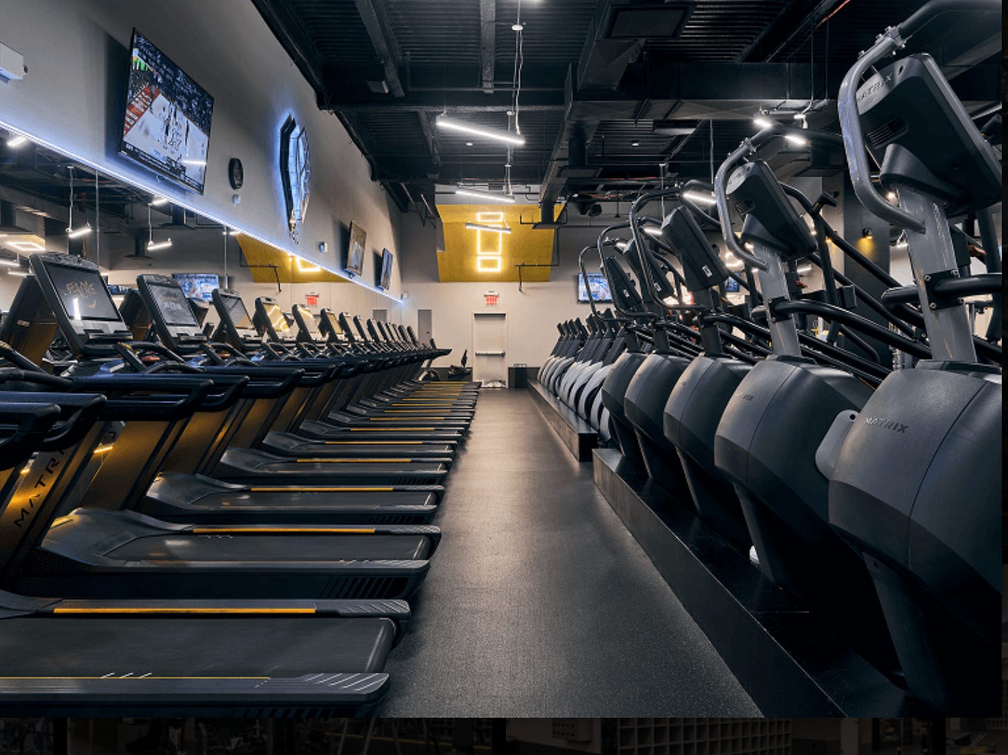 A row of fitness center treadmills