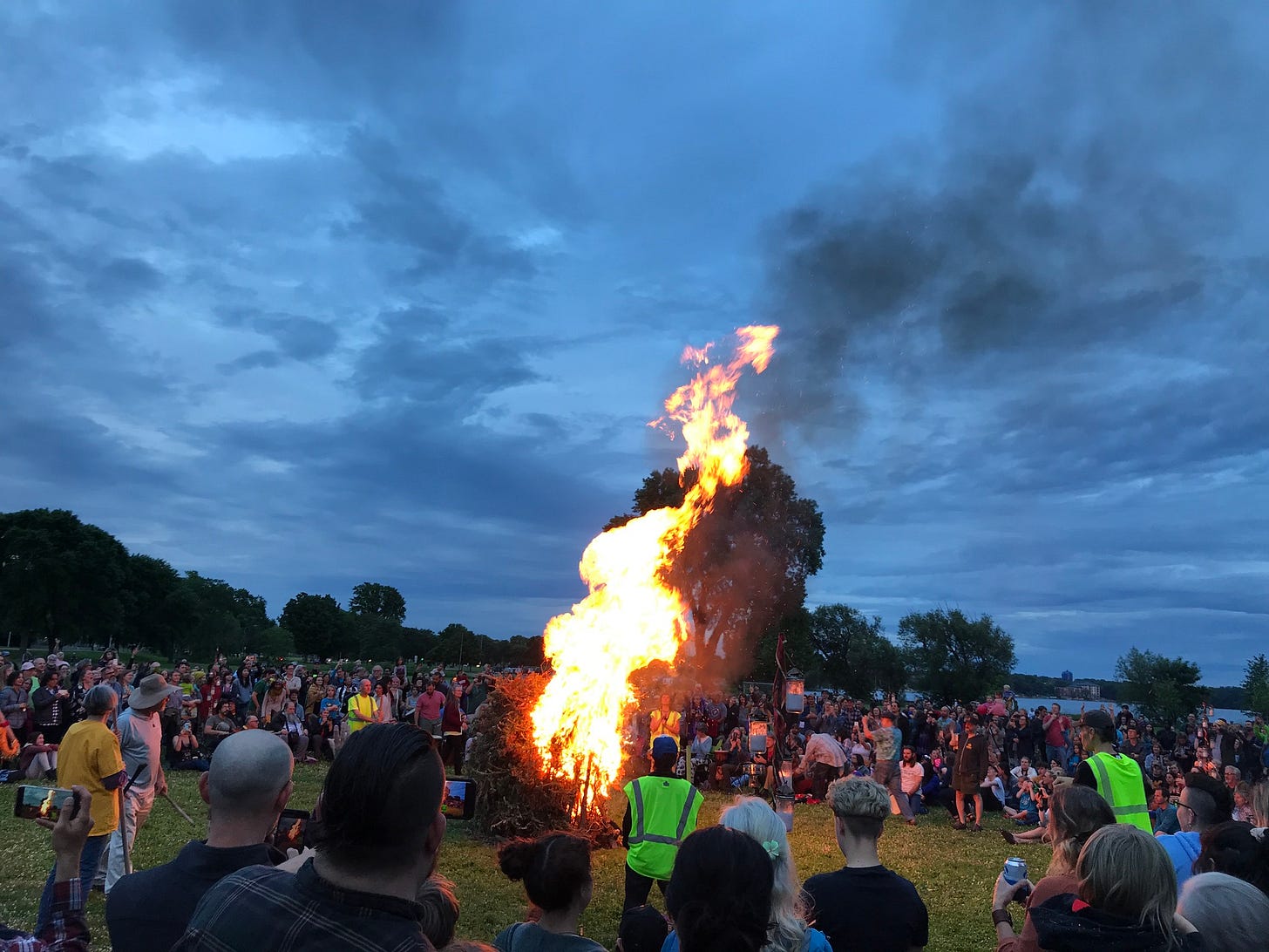 May be an image of 1 person, fire and crowd