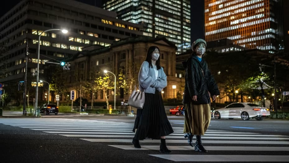 This picture taken on October 27, 2022 shows pedestrians walking in front of the Bank of Japan (BoJ) headquarters in Tokyo. (Photo by Philip FONG / AFP) (Photo by PHILIP FONG/AFP via Getty Images)