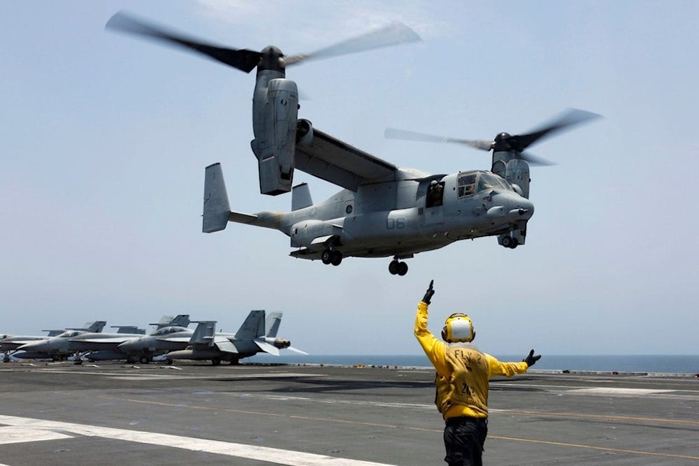 Aviation Boatswain's Mate 2nd Class Nicholas Hawkins signals an MV-22 Osprey to land on the flight deck of the USS Abraham Lincoln in the Arabian Sea on May 17, 2019. (AP/US Navy)