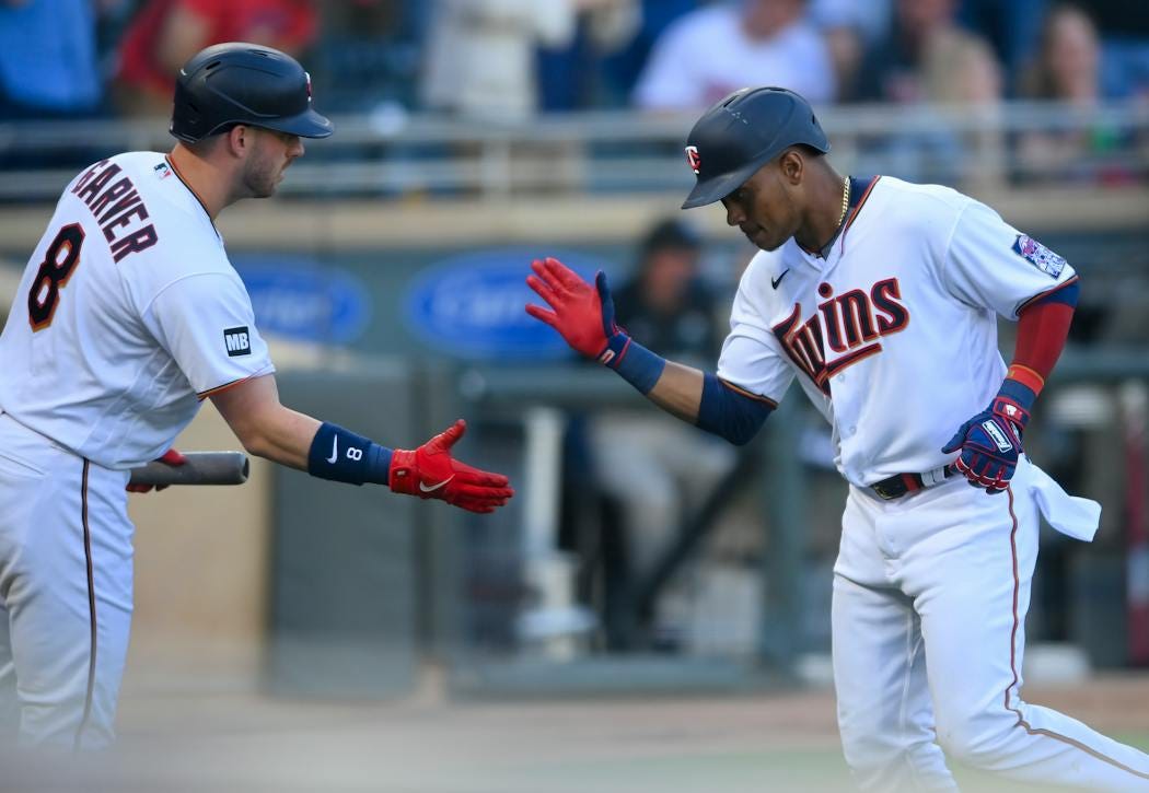 Minnesota Twins shortstop Jorge Polanco (11) high fived catcher Mitch Garver (8) after a solo home run hit by Polanco in the bottom of the second inni