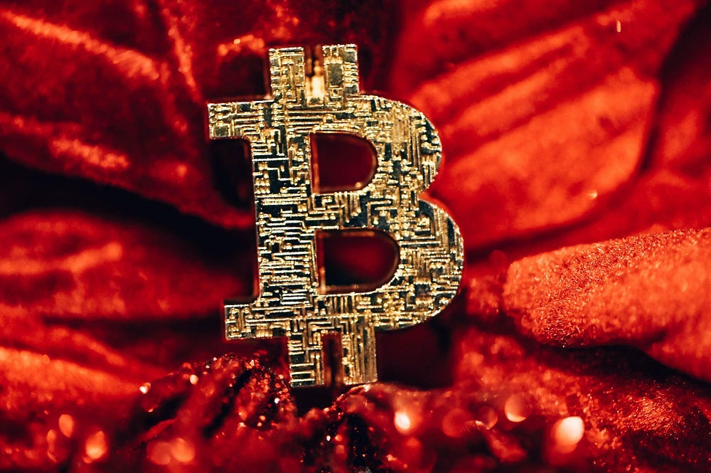 There is a Bitcoin sign on the red fabric on the picture