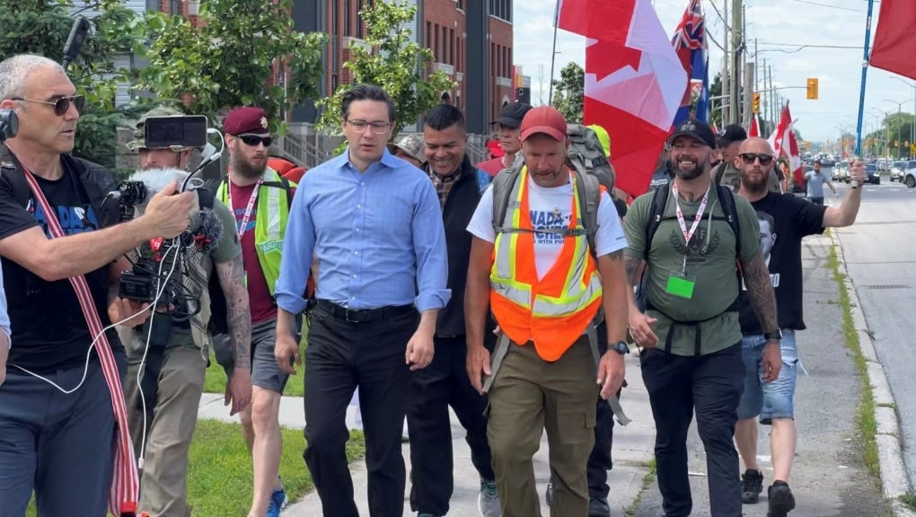 Conservative Party leadership candidate Pierre Poilievre marches with Canadian veteran James Topp as the Canada Marches "March to Freedom" arrives in Ottawa. (Jeremie Charron/CTV News Ottawa) 