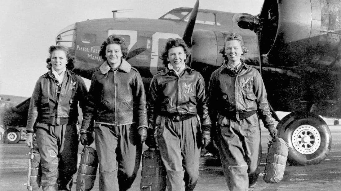Four of the female pilots are depicted walking with their plane in the background.