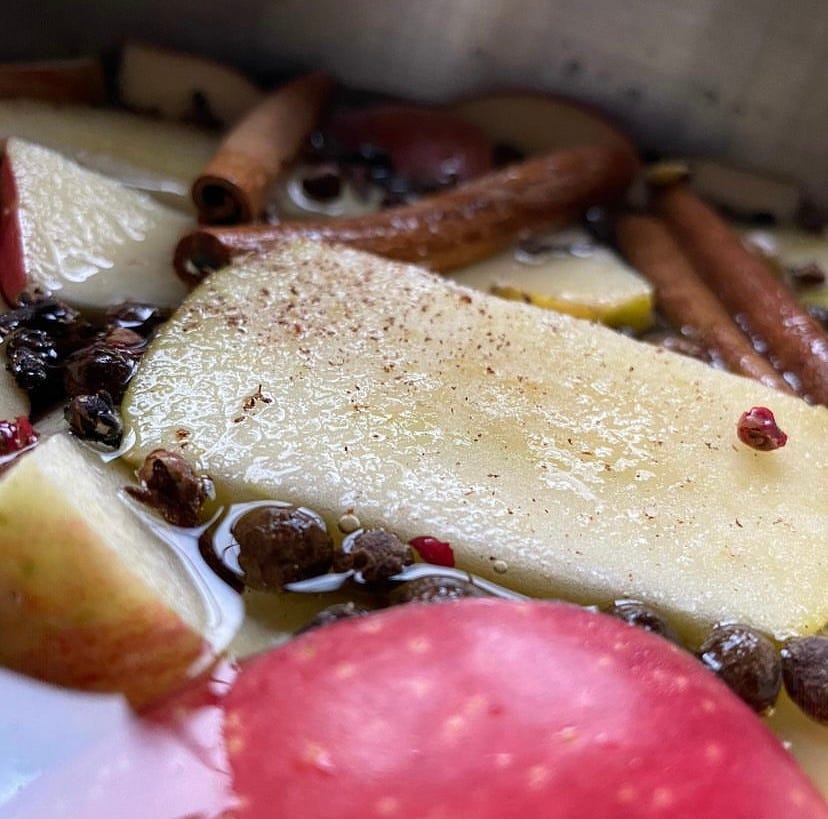 sliced apples and cinnamon sticks in a pot