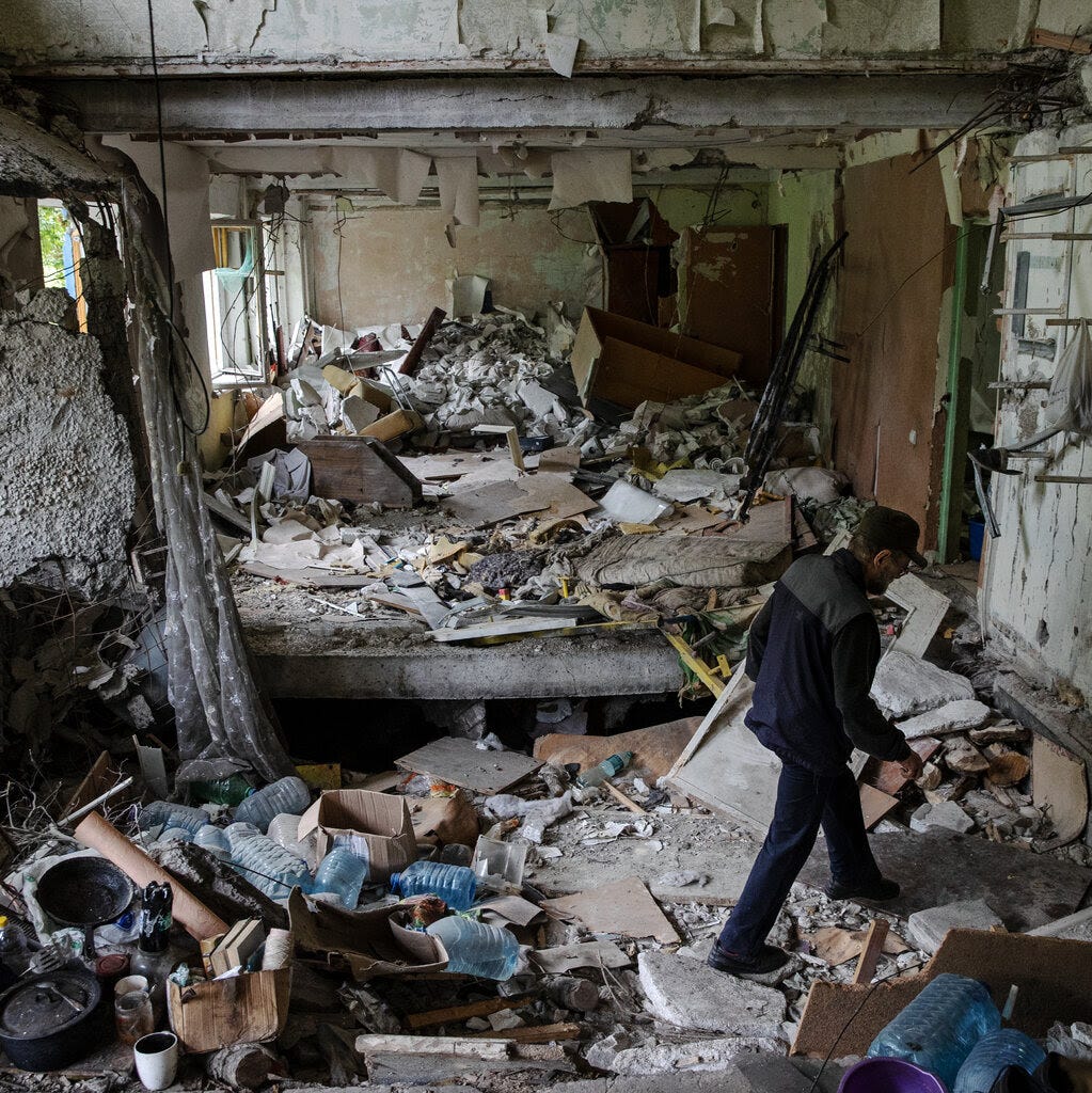 A man rummages through the remains of his heavily damaged apartment building in Avdiivka last June.