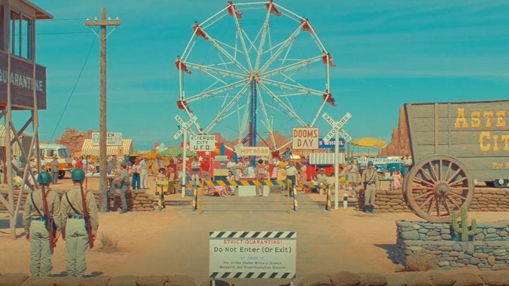 This may contain: an amusement park with people standing in front of the ferris wheel and other things on display