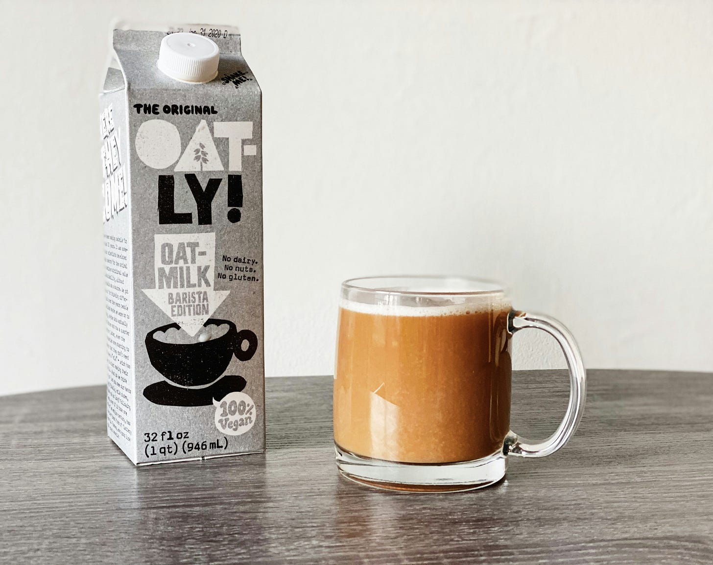 oatly oat milk next to coffee drink