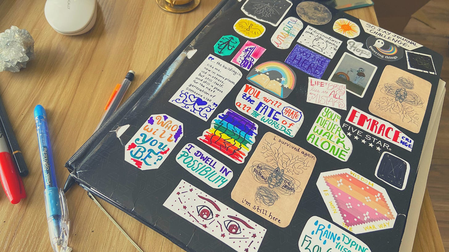 A black folder covered entirely in an array of colorful stickers with quotes and doodles on them