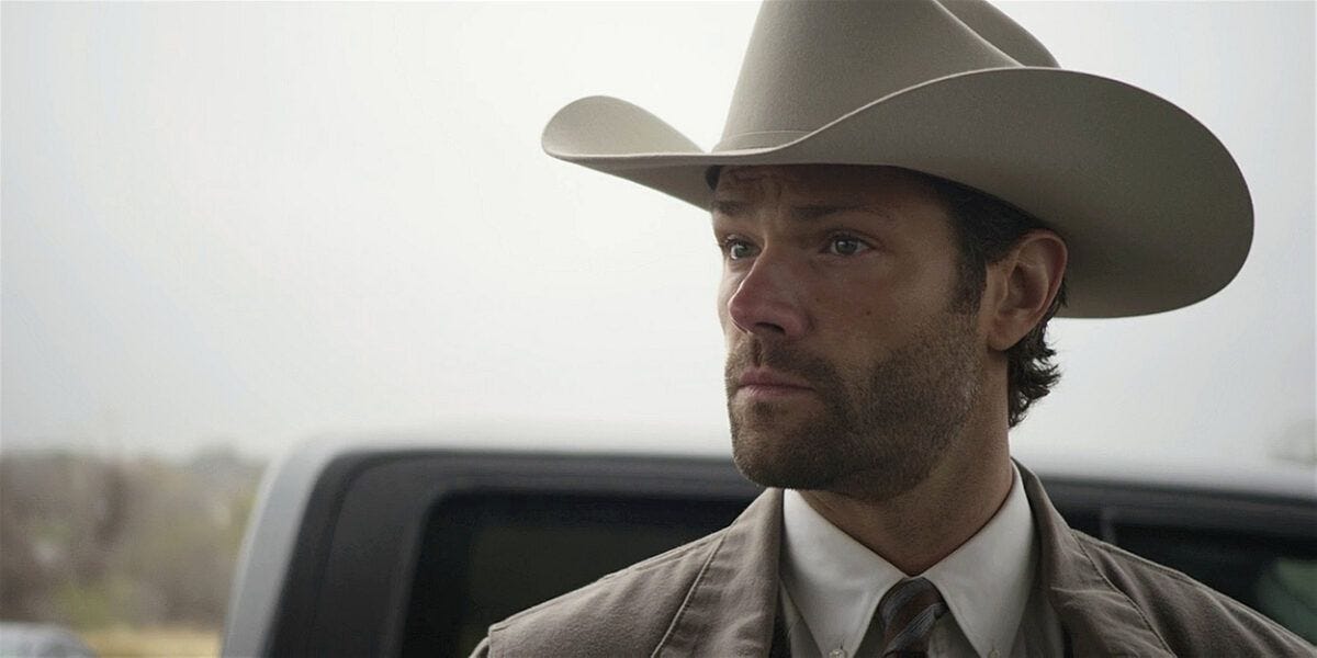 Jared Padalecki in Walker white cowboy hat with scruffy face.