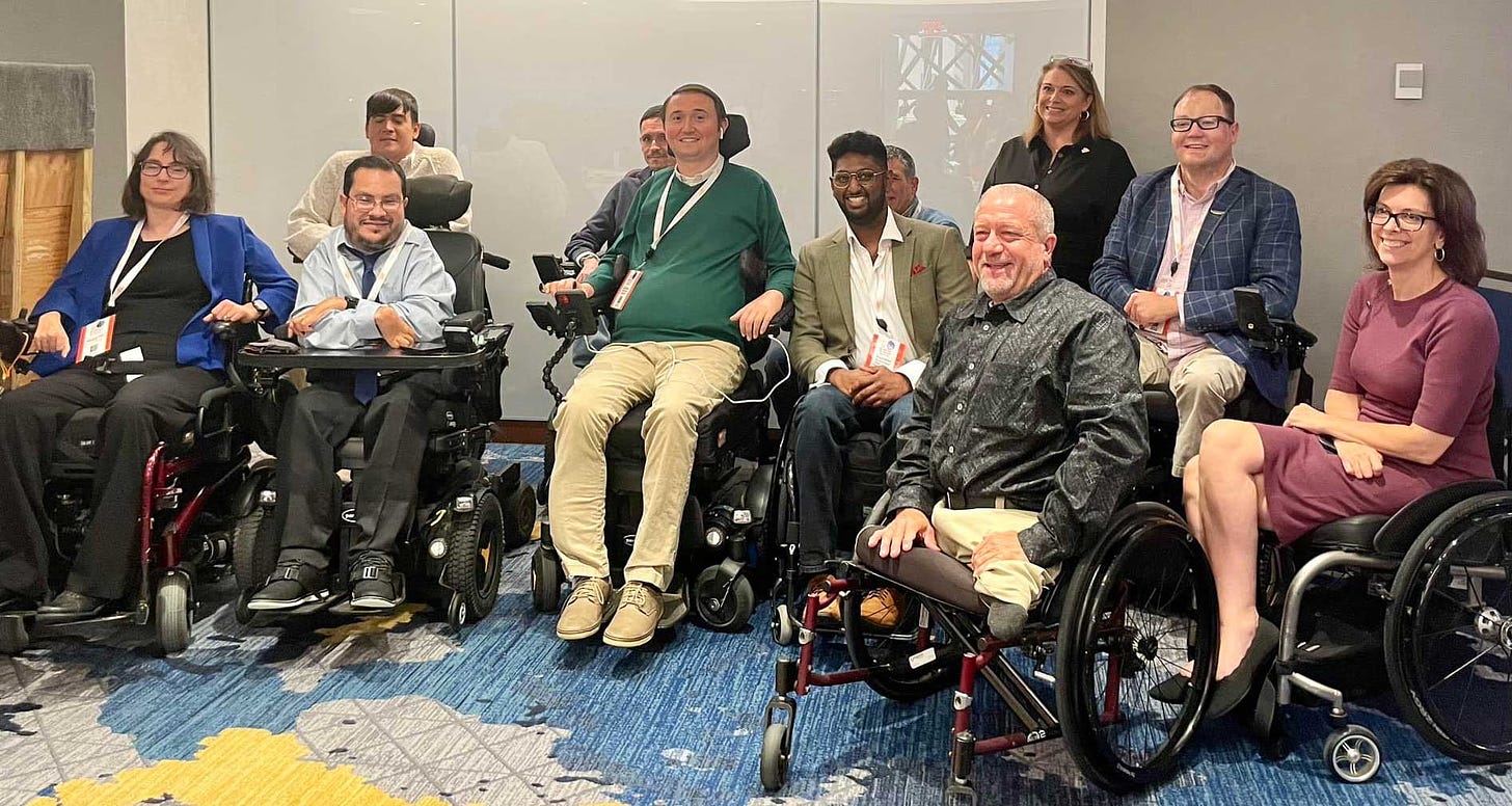 John pictured with a group of wheelchair users at the conference.