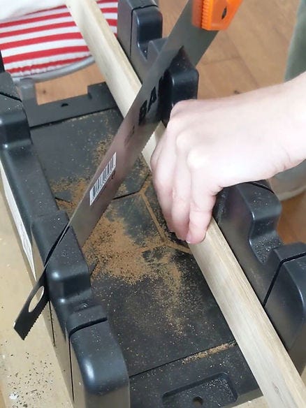 Sawing using mitre box and handsaw