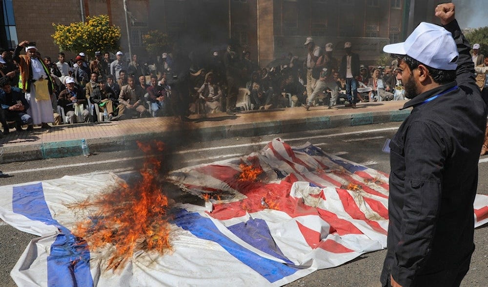 Yemeni graduates of fighting courses burn Israeli, British and American flags in support of Gaza during a parade, in Sanaa, Yemen, Wednesday, Dec. 4, 2024. (AP)