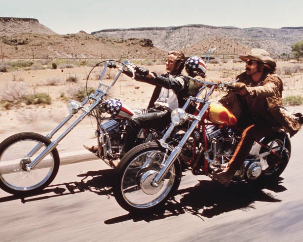 American actors Dennis Hopper and Peter Fonda ride through the Desert on motorcycles in a scene from the film 'Easy Rider', directed by Hopper, 1969.