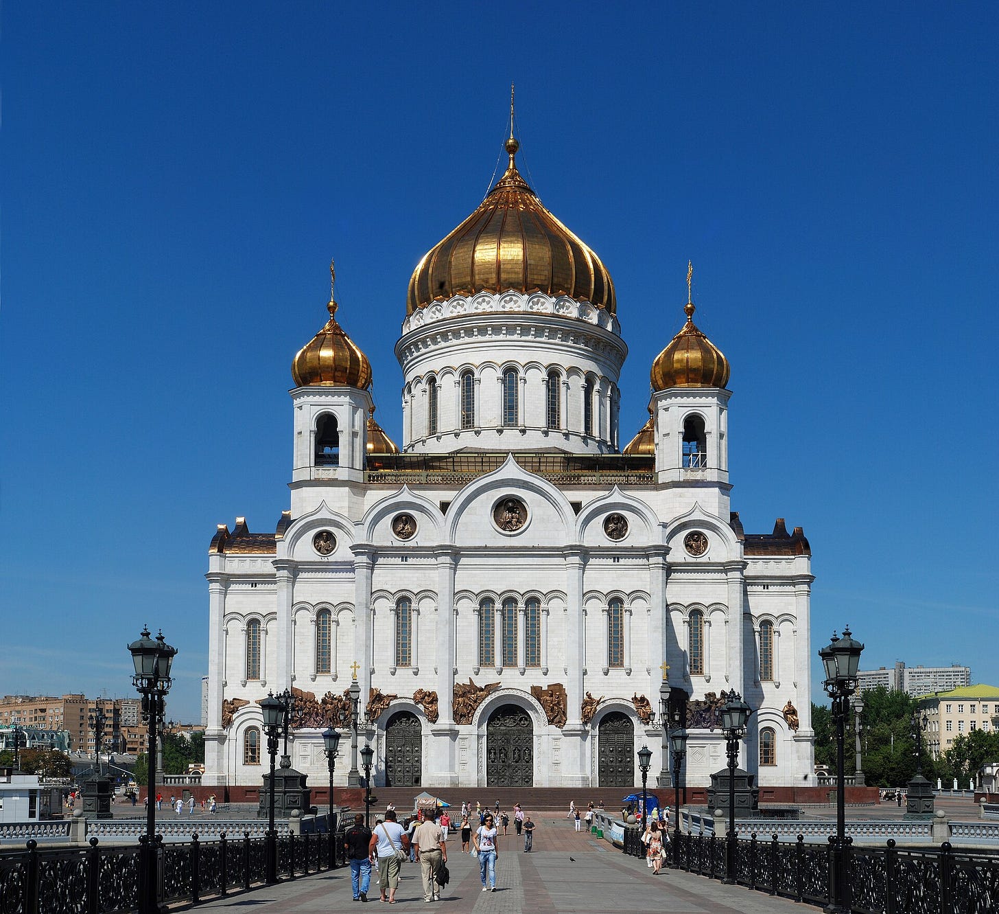 A white building with gold domes with Cathedral of Christ the Saviour in the background

AI-generated content may be incorrect.
