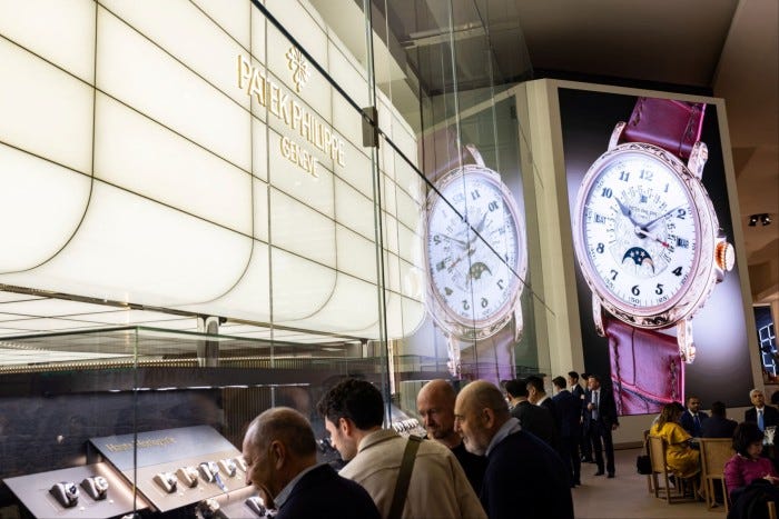 Visitors look at watch models at the Patek Philippe booth at the Watches and Wonders exhibition in Geneva, Switzerland, April 9, 2024
