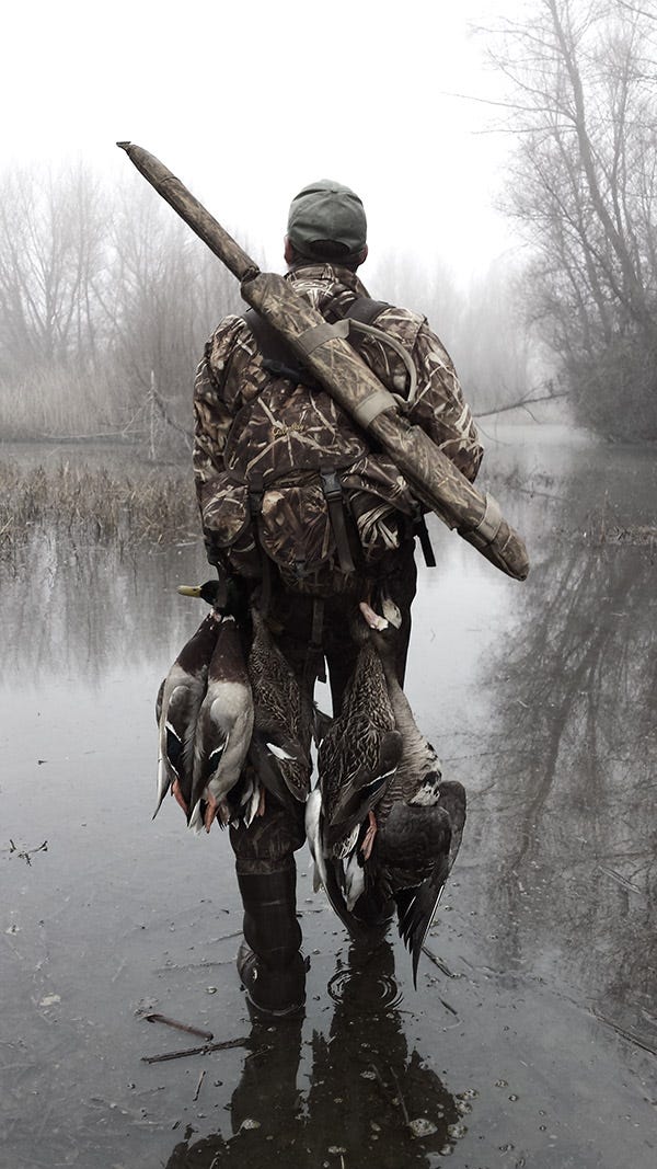 Hank Shaw with a strap full of ducks and geese. 