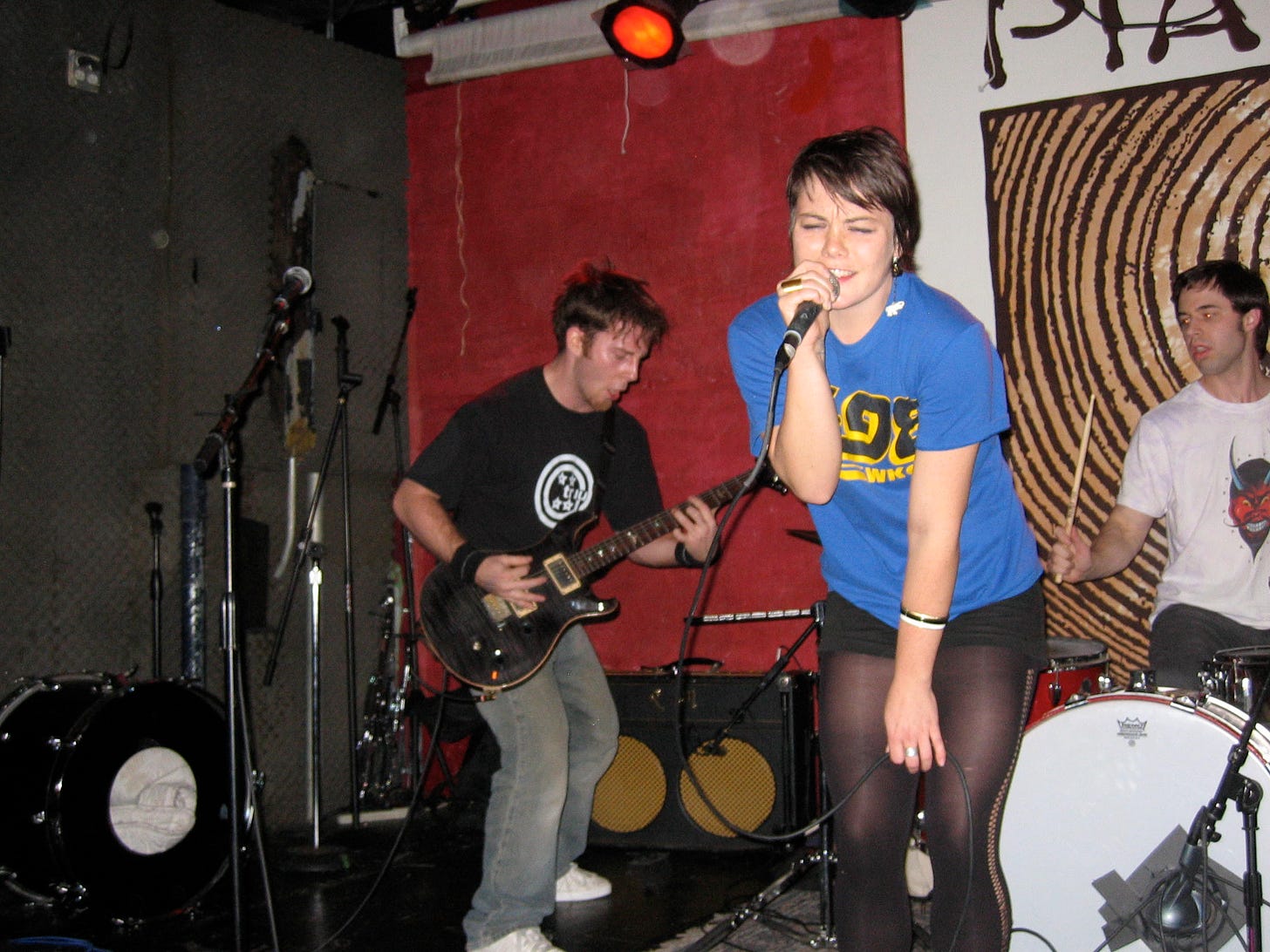 A picture of three people playing in a band.