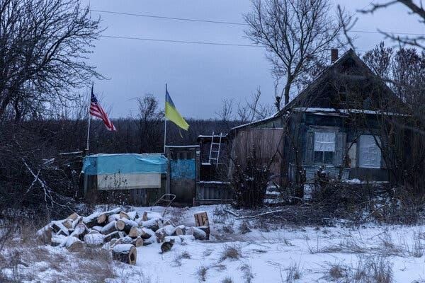 A house with flags in the snow Description automatically generated