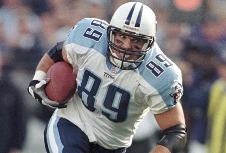 FILE - Tennessee Titans tight end Frank Wycheck runs with the ball during a football game against the Baltimore Ravens, Dec. 5, 1999, in Baltimore. The three-time Pro Bowler Wycheck, who threw the lateral that started the “Music City Miracle” launching the Tennessee Titans' run to the franchise's lone Super Bowl appearance, has died at age 52. Wycheck died at his Chattanooga, Tenn., home after an apparent fall where he hit his head Saturday morning, Dec. 9, 2023, according to a statement from his family released through the Legacy consulting firm. (AP Photo/Roberto Borea, File)