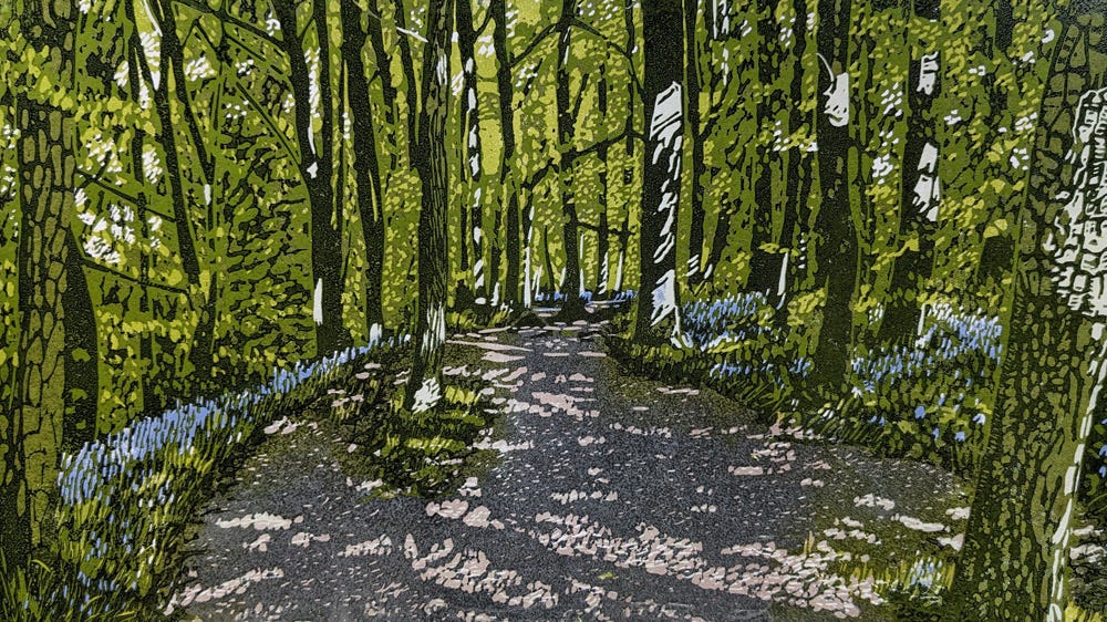 'Bluebell Path' - a reduction linoprint by Jane Duke showing a shady woodland path lined with bluebells.
