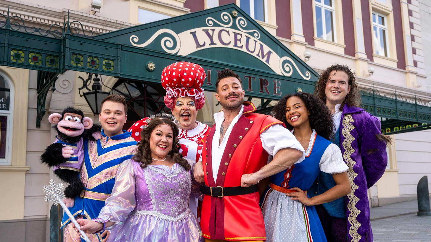 The cast of Beauty And The Beast stand in full costume outside the Lyceum Theatre in Sheffield.