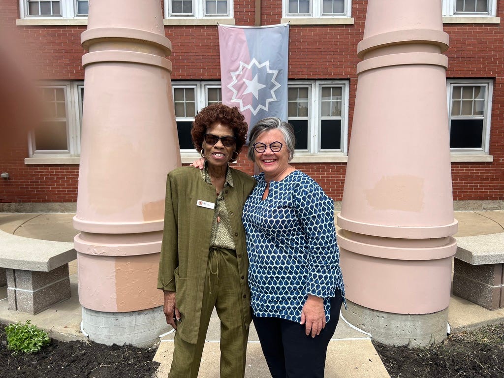 Two women standing between pillars at the Evansville African-American Museum