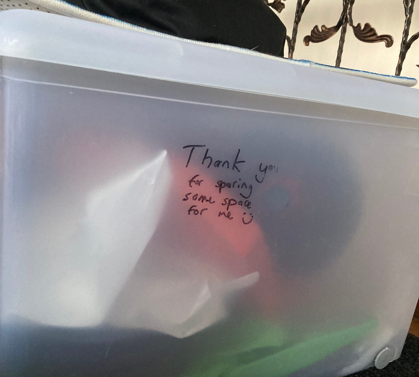 a plastic bin with the following written in marker: "Thank you for sparing some space for me :)"