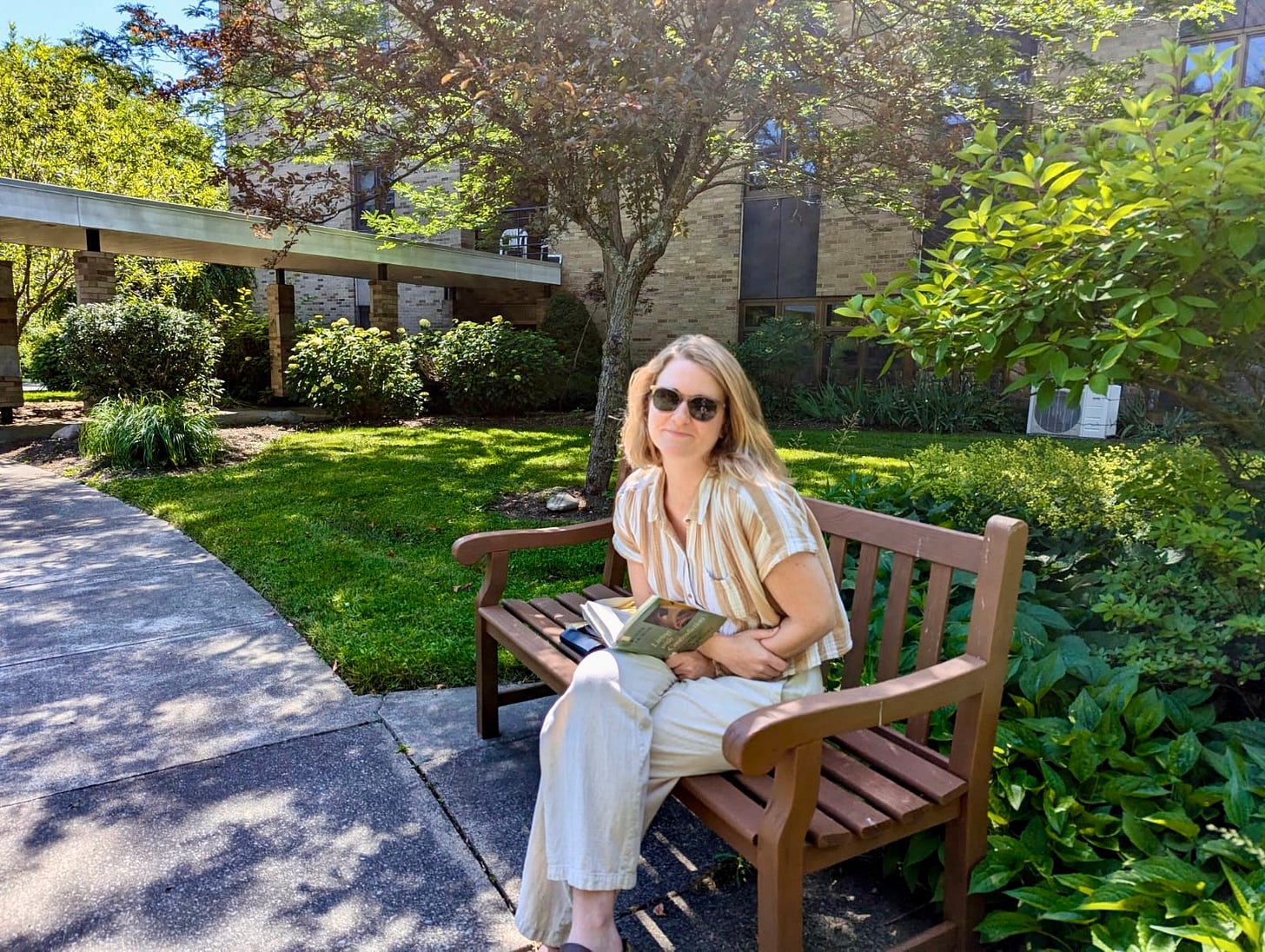 Katie reading a book on a bunch in the monastery gardens Katie reading a book on a bunch in the monastery gardens