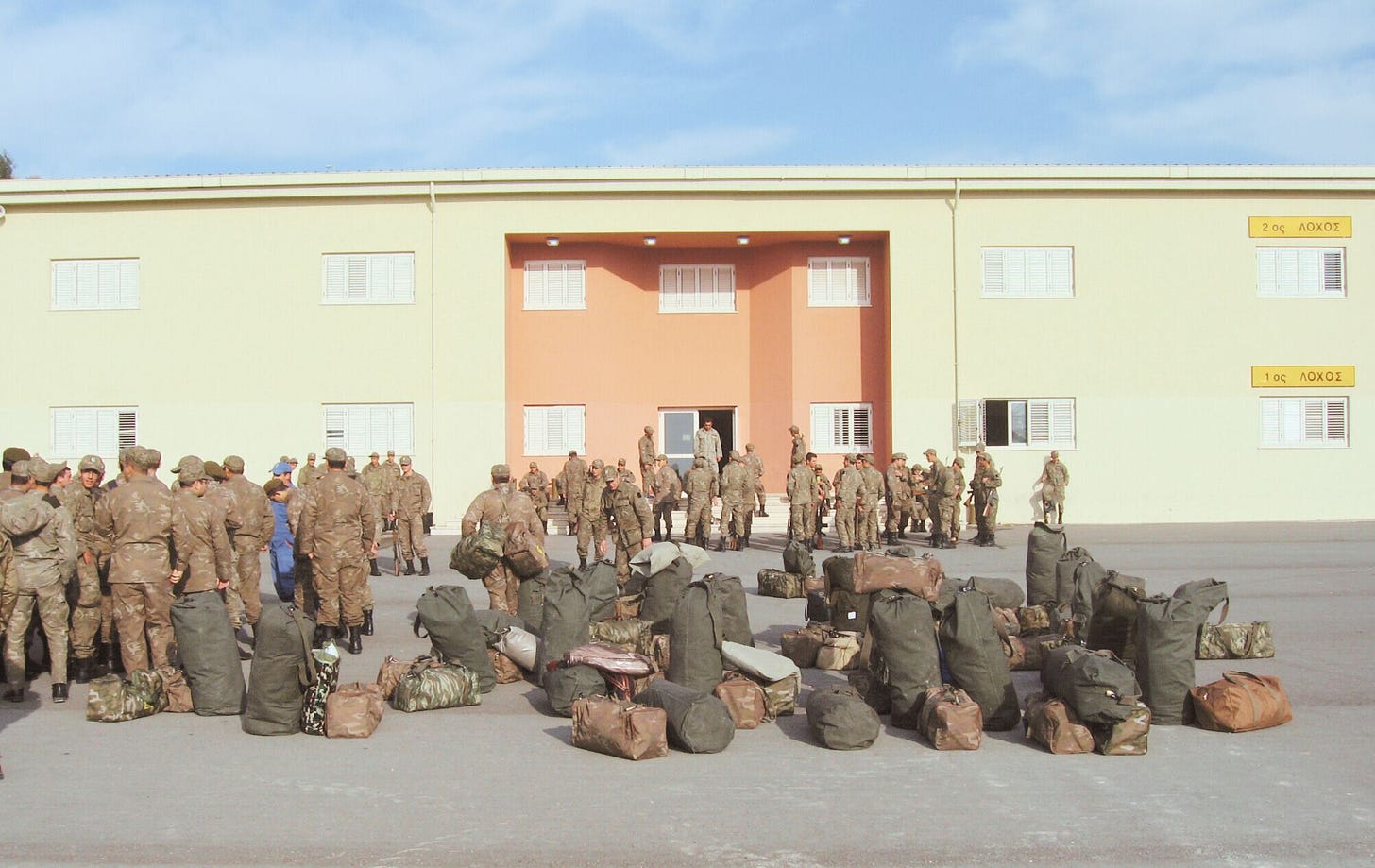 a cluster of army bags in front of the Cypriot 1st company barracks