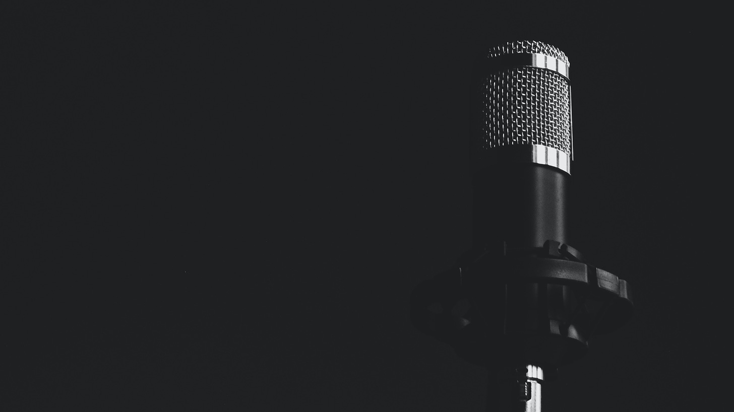 a black microphone against a black wall