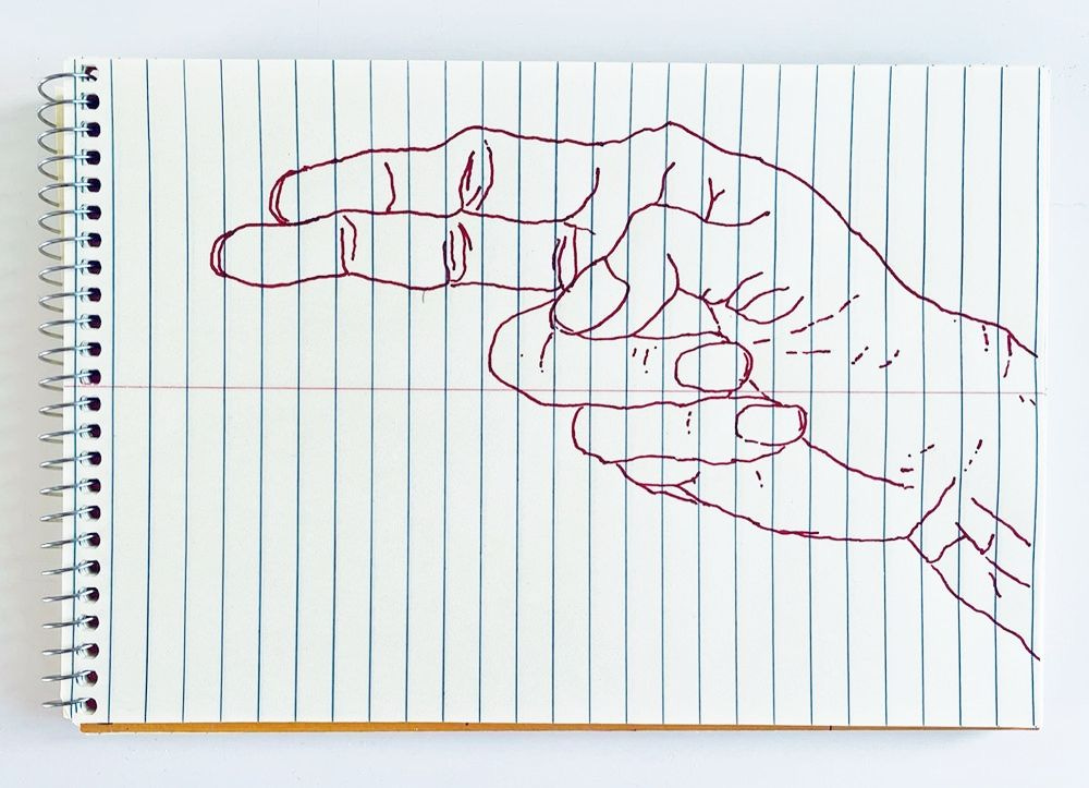 An outline handsketch of a hand shaping the ASL American manual letter “H”, in red ink on a yellow spiral bound steno notebook. 