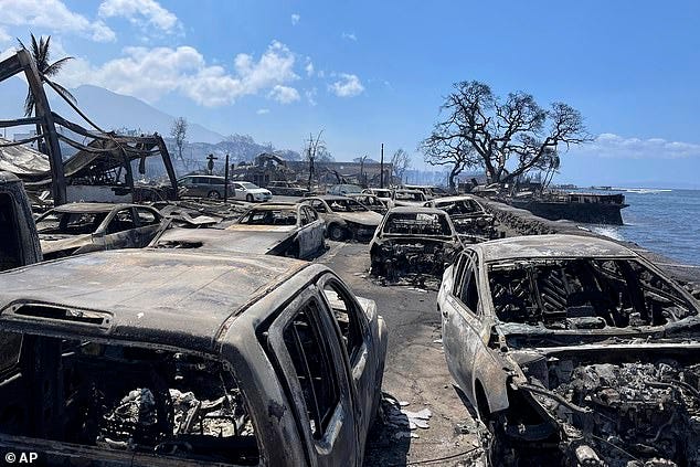 In this photo provided by Tiffany Kidder Winn, burned-out cars sit after a wildfire raged through Lahaina, Hawaii, on Wednesday, Aug. 9, 2023