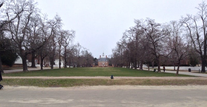 Long grassy area bordered by trees, on the approach to the Governor's Palace