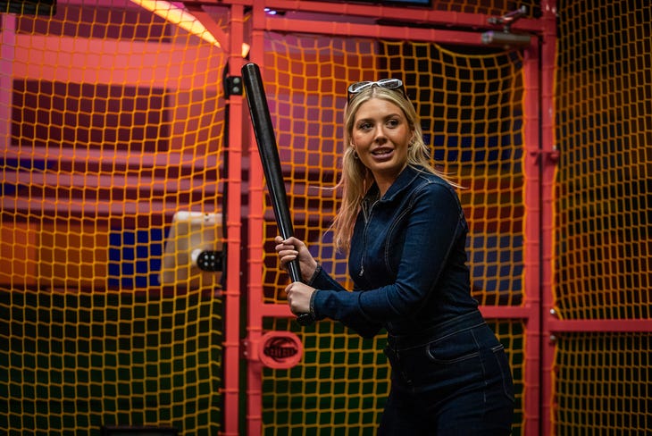 A young woman with a baseball bat