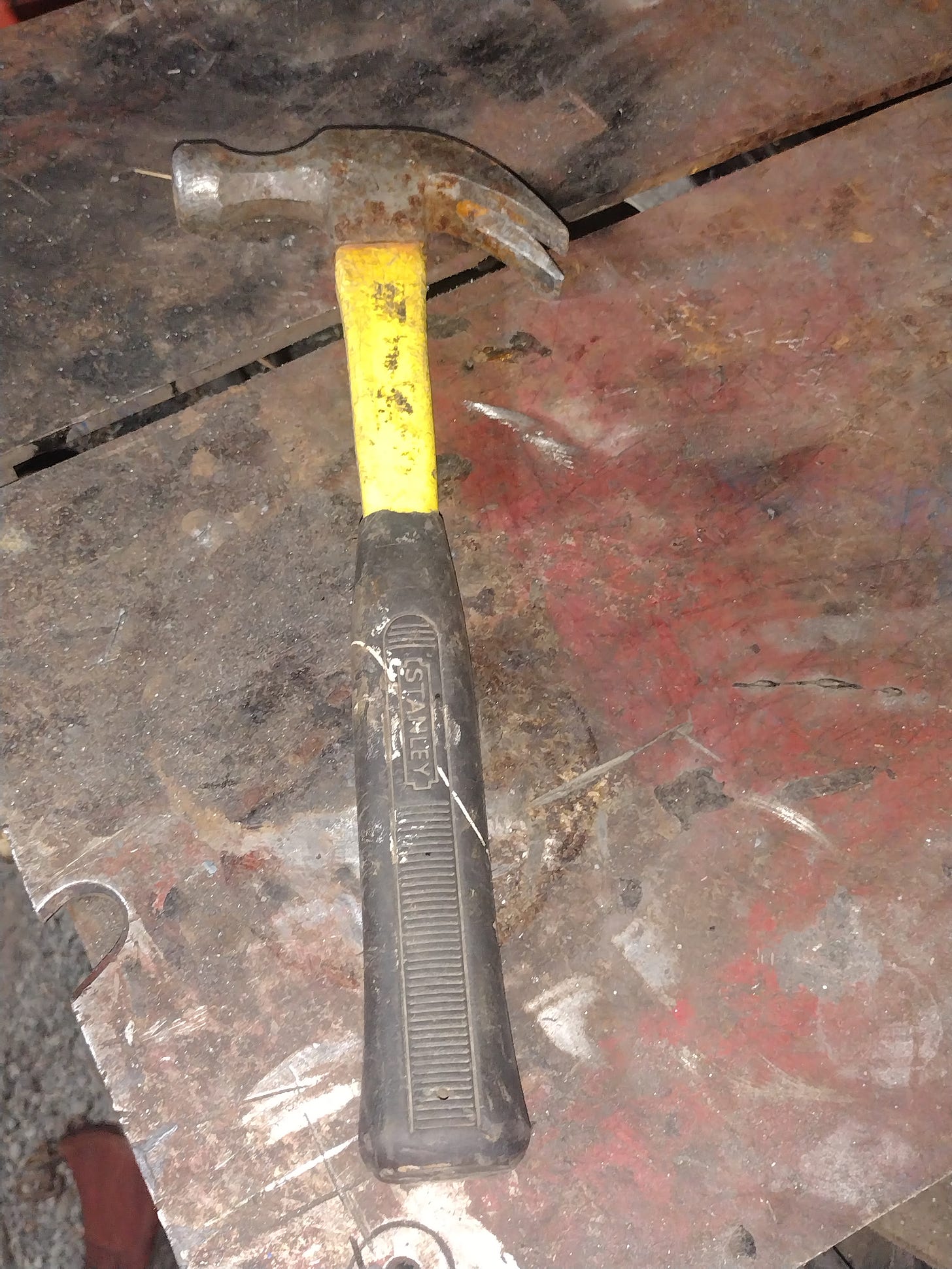 A claw hammer on a steel table