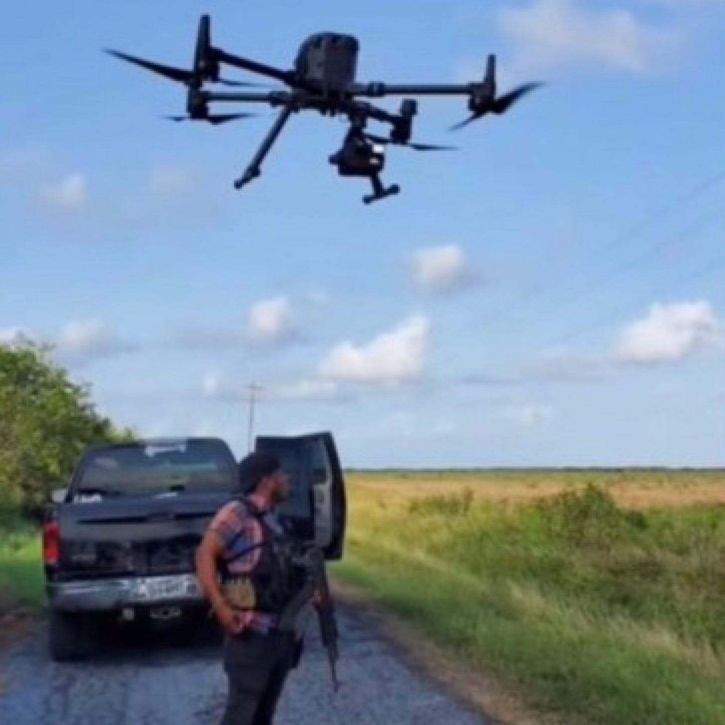 Image from a social media post by the "Scorpions" faction of the Gulf Cartel (CDG) of a drone launching over a gunman in Tamaulipas. Image from a social media post by the "Scorpions" faction of the Gulf Cartel (CDG) of a drone launching over a gunman in Tamaulipas.