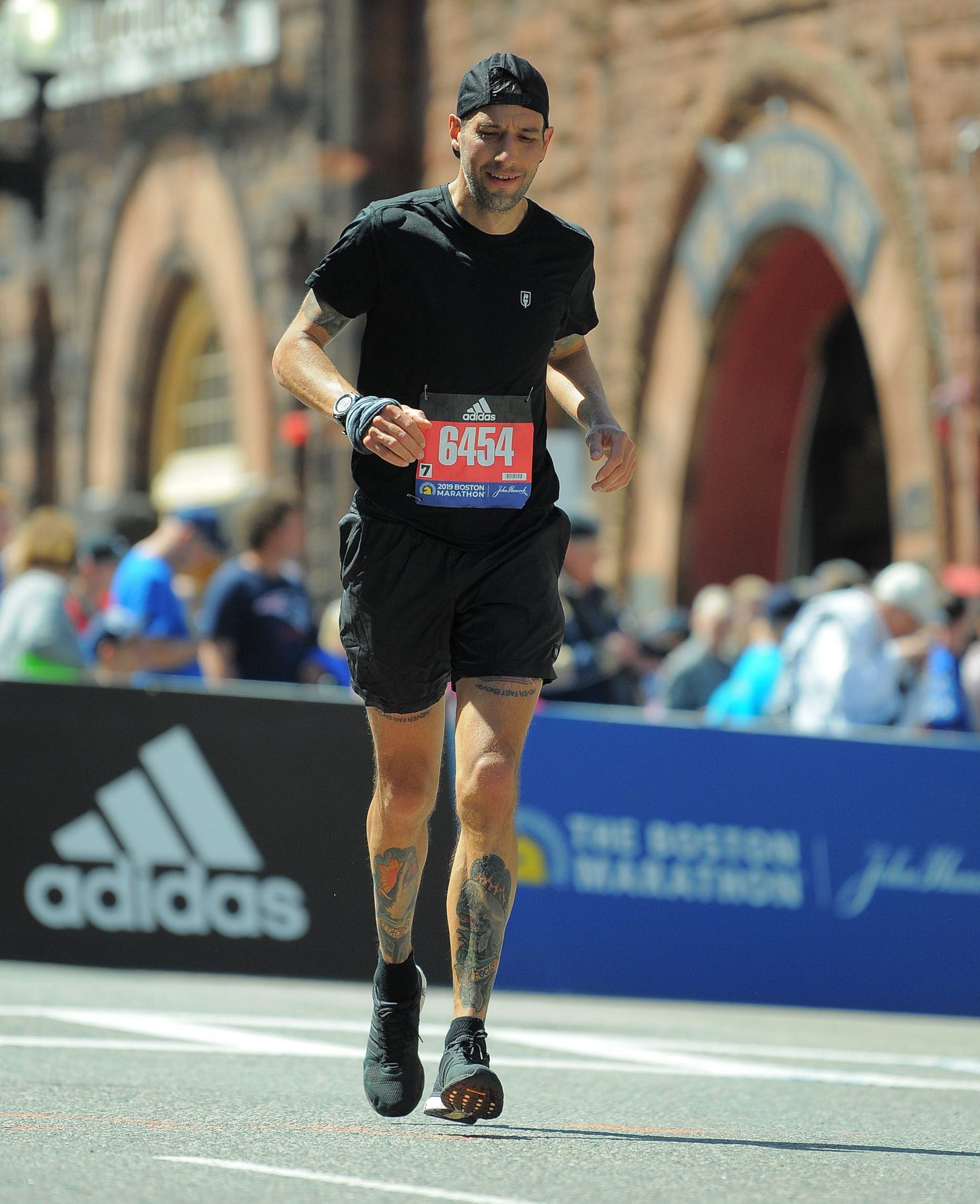 The author running the Boston Marathon with a suffer face