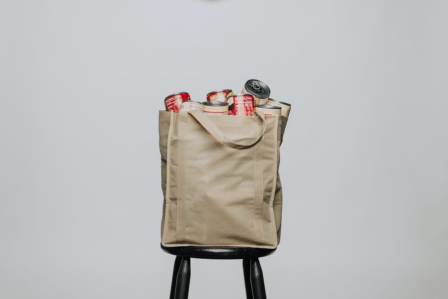bag of canned goods on a stool