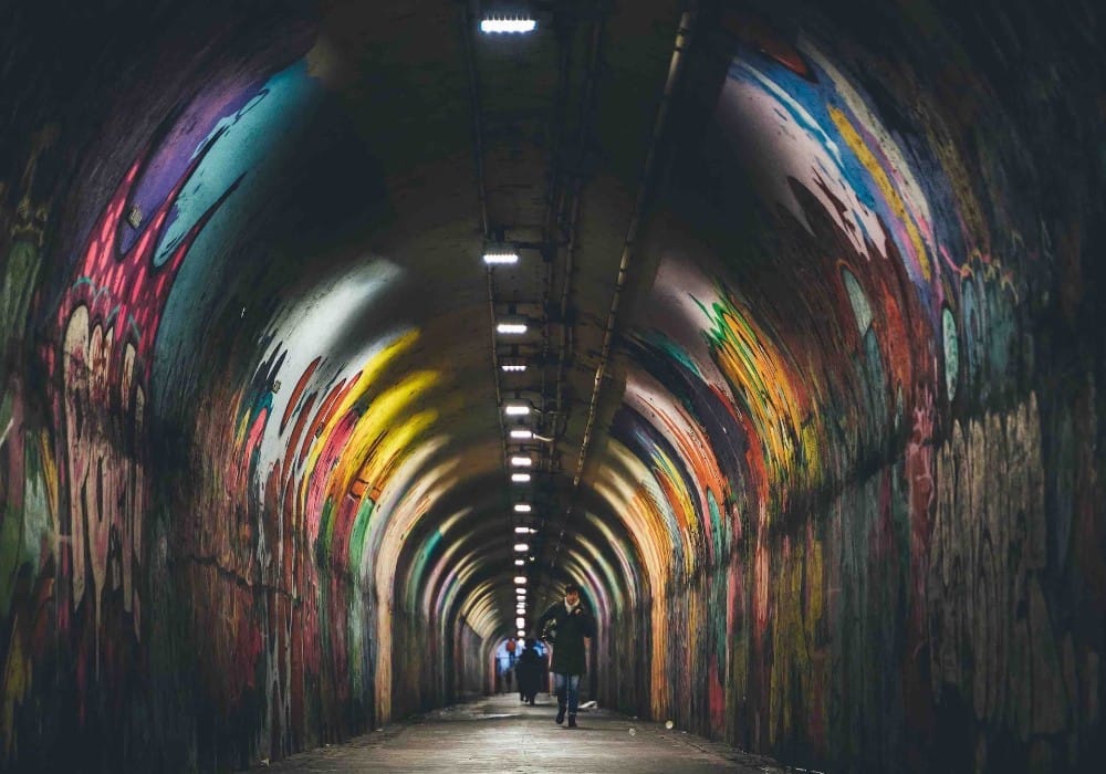 Urban tunnel with colorful graffiti in it
