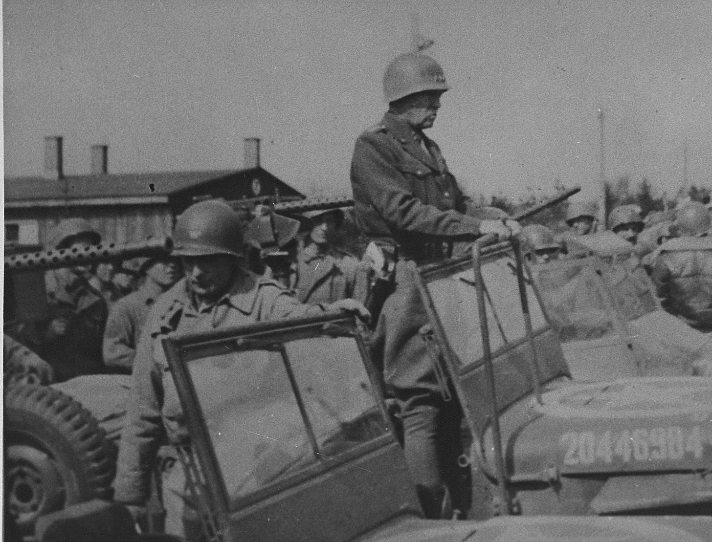 General George Patton (standing in the jeep) prepares to depart from  Ohrdruf after an official tour of the newly liberated camp. - Collections  Search - United States Holocaust Memorial Museum