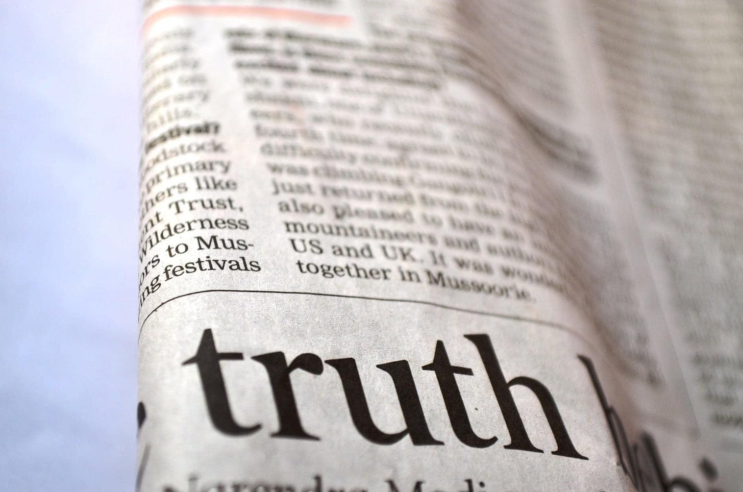 The word "Truth" printed in large type on a newspaper.