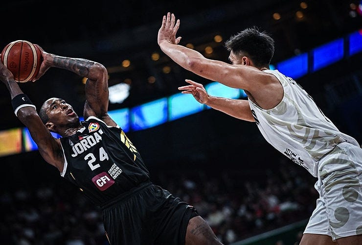 Rondae HollisJefferson shooting a fadeaway shot over a player in a white jersey